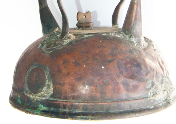 Photo: A polished copper disc covers the hole where the spout used to be